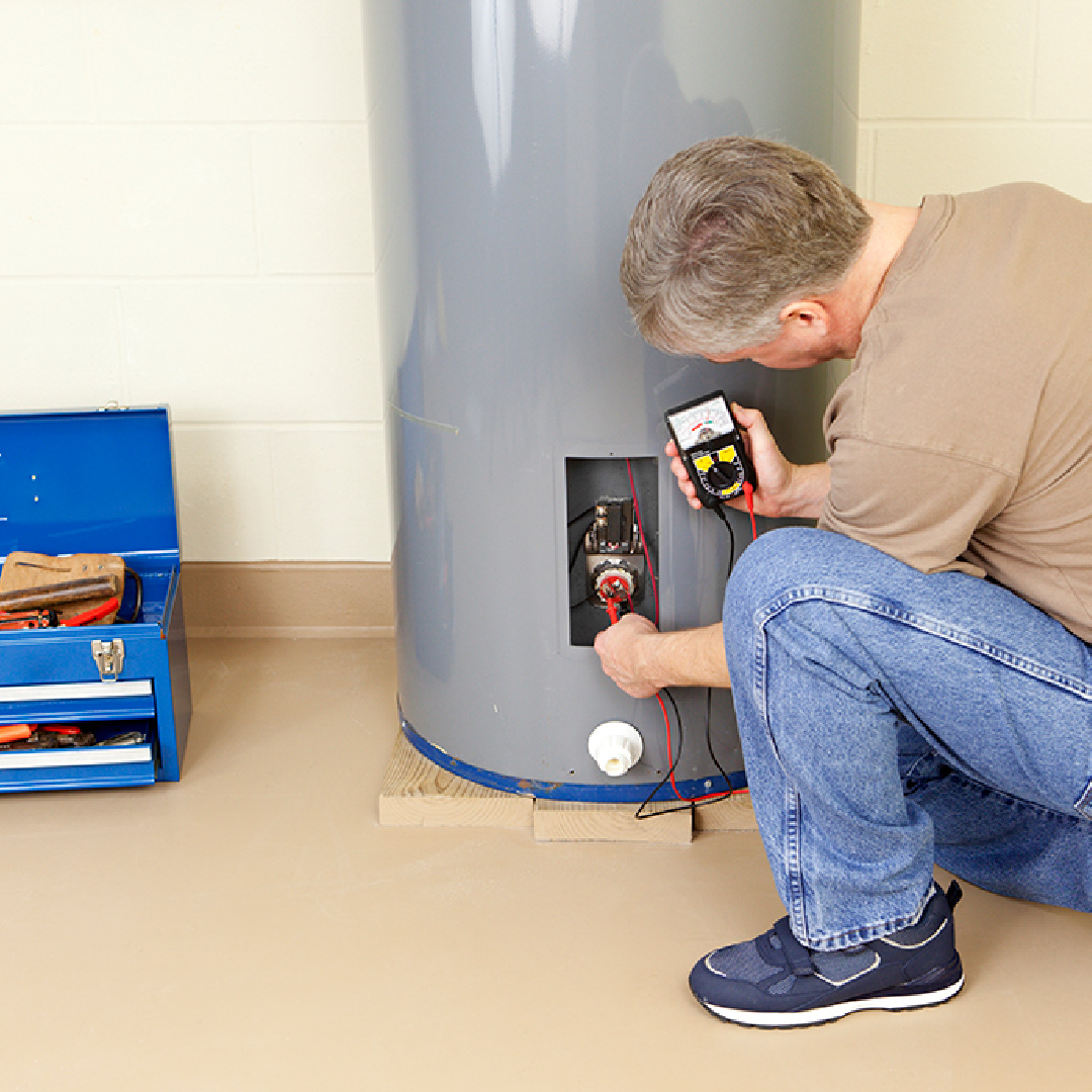A plumber working in a water heater